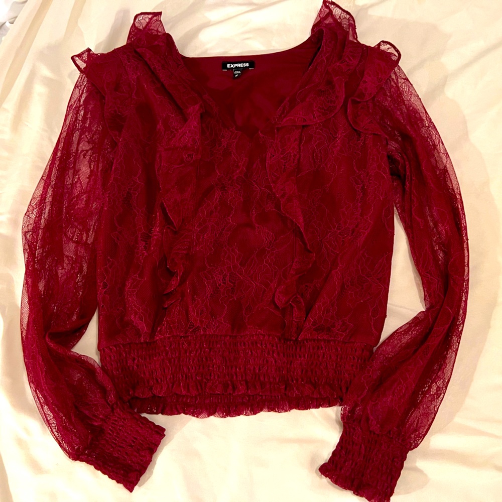 Express top.  Lace sleeves and ruffled detail on front.  Worn once.